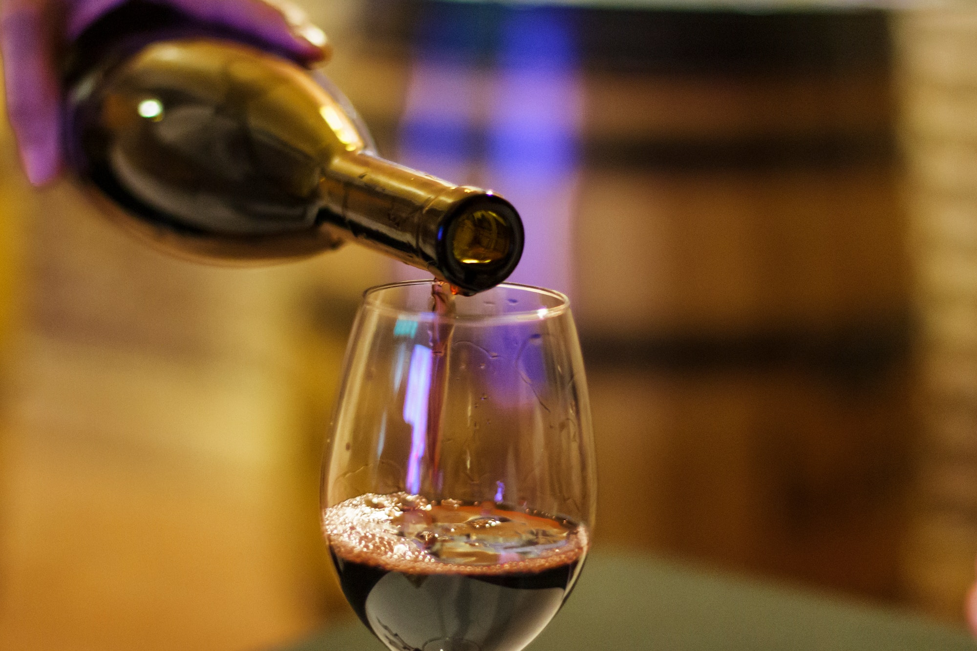 Pouring red wine in a wine glass
